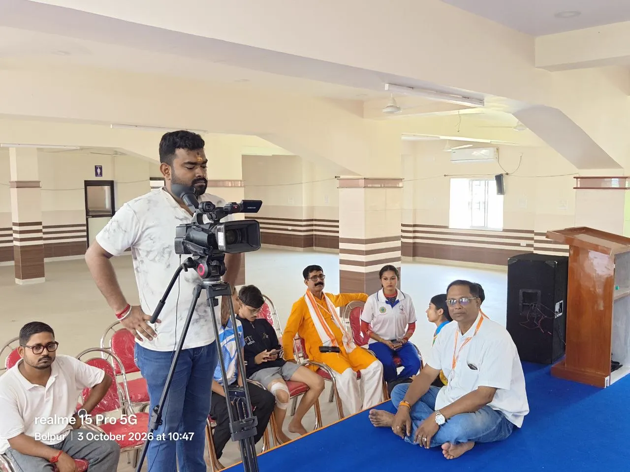 Shyamal Ta, State President of the All Bengal Yogasana Sports Association, seated in the hall at Bharat Sevashram Sangha, Muluk.